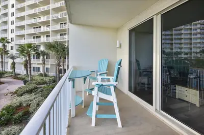 a balcony with blue chairs and a table on a balcony at 225-Shores Of Panama in Panama City Beach