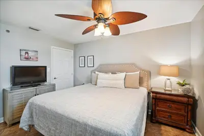 a bedroom with a bed and a ceiling fan at 701 Sterling Beach in Panama City Beach