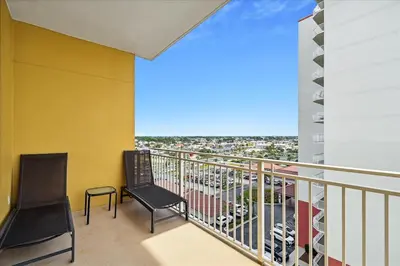a balcony with a chair and a view of a parking lot at 701 Sterling Beach in Panama City Beach