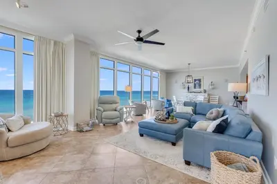 a living room with a blue couch and chairs at 701 Sterling Beach in Panama City Beach