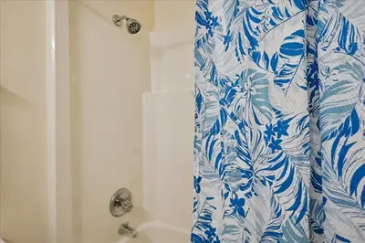 a blue and white shower curtain in a bathroom at 721 Top Of The Gulf in Panama City Beach