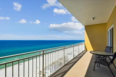 a balcony with a table and chairs and the ocean at 1504 Sterling Beach in Panama City Beach