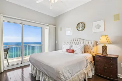 a bedroom with a bed and a large window at 1504 Sterling Beach in Panama City Beach
