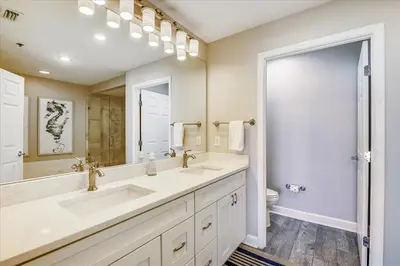 a bathroom with two sinks and a large mirror at 302 Sterling Beach in Panama City Beach