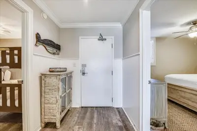 a bedroom with a white door and a bed at 302 Sterling Beach in Panama City Beach