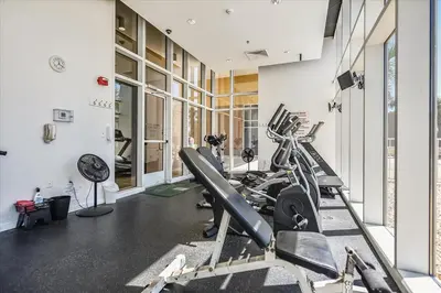 a gym with treadmills and elliptical machines at 302 Sterling Beach in Panama City Beach