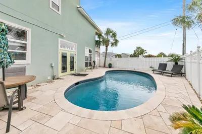 a swimming pool in the backyard of a house at Blue Turtle Beach House by Emerald Coast Retreats in Panama City Beach