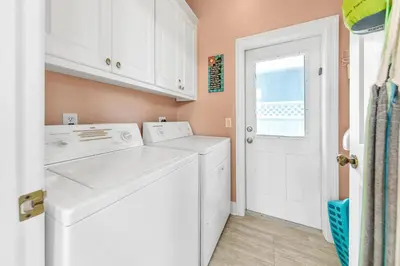 a laundry room with a washer and dryer at Blue Turtle Beach House by Emerald Coast Retreats in Panama City Beach