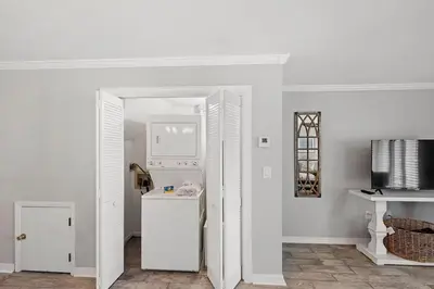 a kitchen with white walls and a white refrigerator at Portside 2SG- Seabreeze Townhome by Emerald Coast Retreats in Panama City Beach