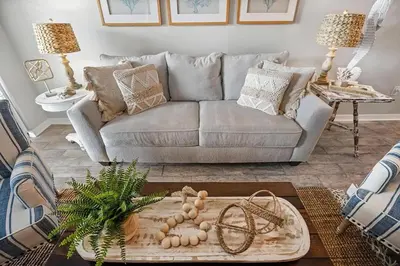 a living room with a couch and a table at Portside 2SG- Seabreeze Townhome by Emerald Coast Retreats in Panama City Beach