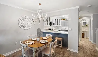 a dining room and kitchen with a table and chairs at Portside 2SG- Seabreeze Townhome by Emerald Coast Retreats in Panama City Beach