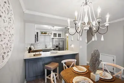 a kitchen and dining room with a chandelier at Portside 2SG- Seabreeze Townhome by Emerald Coast Retreats in Panama City Beach