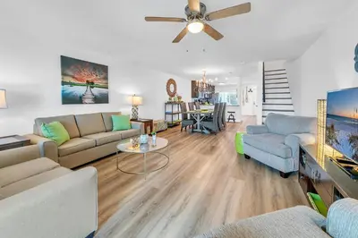 a living room with two couches and a ceiling fan at Largo Mar 106 by Emerald Coast Retreats in Panama City Beach