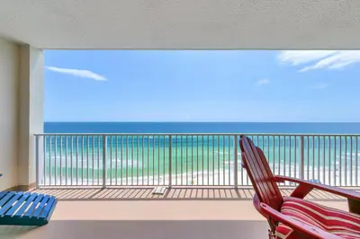 a balcony with two chairs and a view of the ocean at Ocean Reef 1204 in Panama City Beach