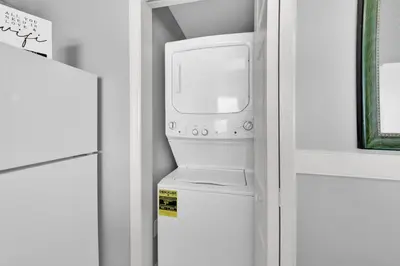 a refrigerator with a washer and dryer in a kitchen at Beachfront Unit-Majestic Beach Resort in Panama City Beach