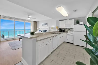 a kitchen with white appliances and a view of the ocean at Beachfront Unit-Majestic Beach Resort in Panama City Beach