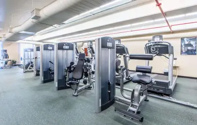a gym with several treadmills and cardio machines at Beachfront Unit-Majestic Beach Resort in Panama City Beach