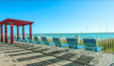 a group of chairs sitting on the beach at Beachfront Unit-Majestic Beach Resort in Panama City Beach