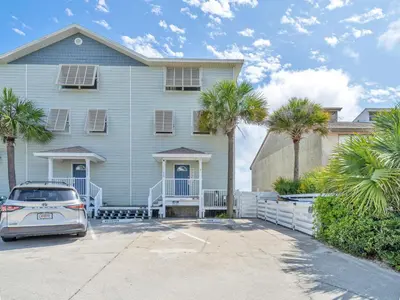 a house with a car parked in front of it at Sunset Sanctuary by Emerald Coast Retreats in Panama City Beach