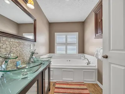a bathroom with two sinks and a bath tub at Sunset Sanctuary by Emerald Coast Retreats in Panama City Beach