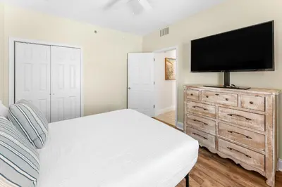 a bedroom with a bed and a flat screen tv at Laketown Wharf #0628 in Panama City Beach