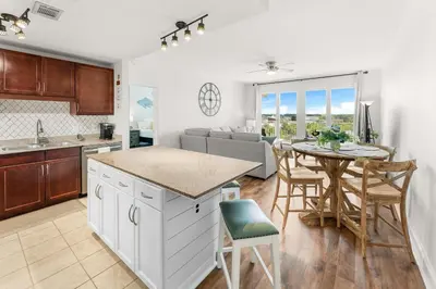 a kitchen and living room with a table and a dining room at Laketown Wharf #0628 in Panama City Beach