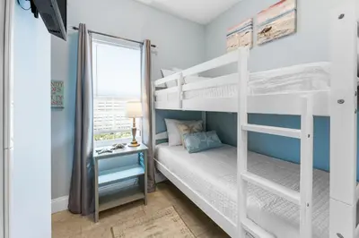 a bedroom with two bunk beds and a window at Laketown Wharf #0628 in Panama City Beach