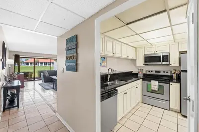 a kitchen with a sink and a stove at Edgewater Golf Villa 605 in Panama City Beach