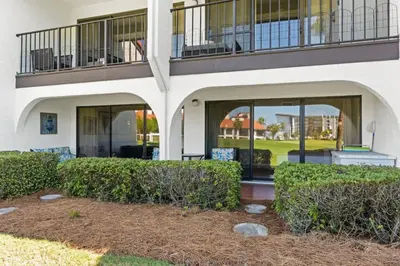 a building with windows and bushes in front of it at Edgewater Golf Villa 605 in Panama City Beach