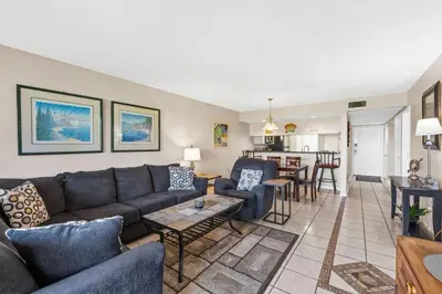 a living room with a couch and a table at Edgewater Golf Villa 605 in Panama City Beach