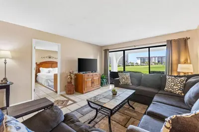 a living room with a couch and a table at Edgewater Golf Villa 605 in Panama City Beach