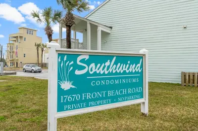 a sign in the grass in front of a house at Southwinds Unit D3 in Panama City Beach