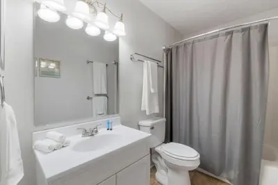 a white bathroom with a sink and a toilet at Southwinds Unit D3 in Panama City Beach