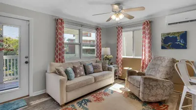 a living room with a couch and a chair at Villas Bahama West 106 in Panama City Beach
