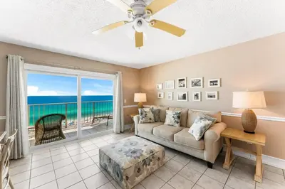 a living room with a couch and a view of the ocean at The Summit 927 in Panama City Beach