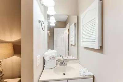 a bathroom with a sink and a mirror at The Summit 927 in Panama City Beach