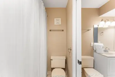a bathroom with a toilet and a sink at The Summit 927 in Panama City Beach