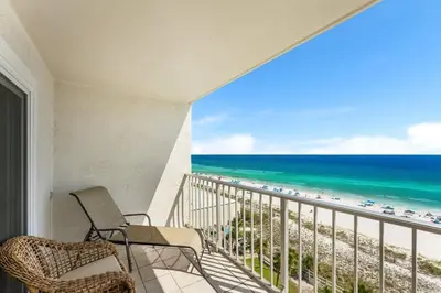 a balcony with chairs and a view of the beach at The Summit 927 in Panama City Beach