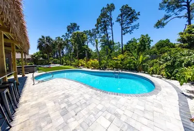 an image of a swimming pool in a resort at Tropical Oasis, Tiki Bar, Pool, Mini Golf, Hot Tub in Panama City Beach
