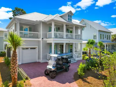 a house with a golf cart in front of it at Cottages at Eastern Lake by Panhandle Getaways in Santa Rosa Beach