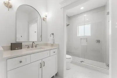 a white bathroom with a sink and a toilet at Cottages at Eastern Lake by Panhandle Getaways in Santa Rosa Beach