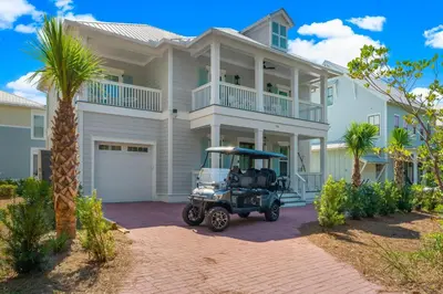 a golf cart parked in front of a house at Cottages at Eastern Lake by Panhandle Getaways in Santa Rosa Beach