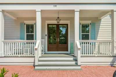 a house with a front porch with a wooden door at Cottages at Eastern Lake by Panhandle Getaways in Santa Rosa Beach