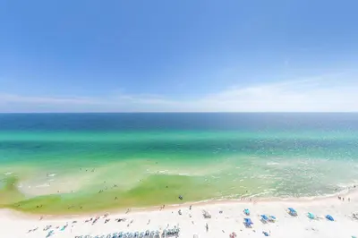 a group of people on a beach with the ocean at Tidewater 1802 in Panama City Beach