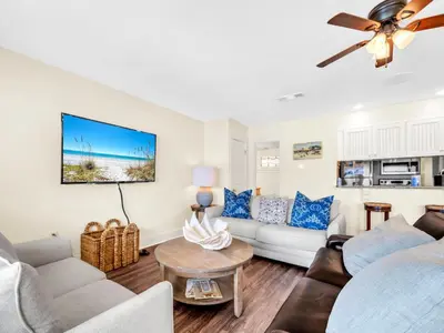 a living room with a couch and a table at Latitude 29 #36 in Panama City Beach