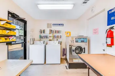 a laundry room with two refrigerators and a washer and dryer at Latitude 29 #36 in Panama City Beach