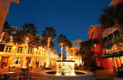a street at night with palm trees and a lantern at Latitude 29 #36 in Panama City Beach