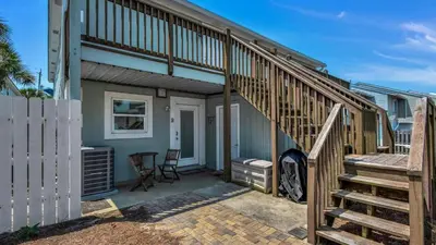 a staircase leading up to a house with a patio at Bahama West by Panhandle Getaways in Panama City Beach