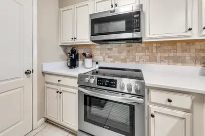 a kitchen with a stainless steel oven and microwave at Dunes of Panama 205D in Panama City Beach