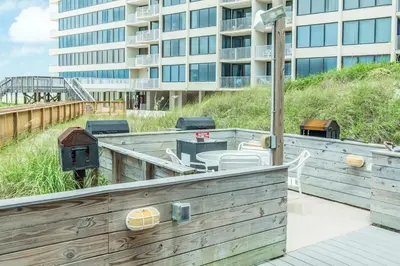 a wooden deck with a building in the background at Dunes of Panama 205D in Panama City Beach